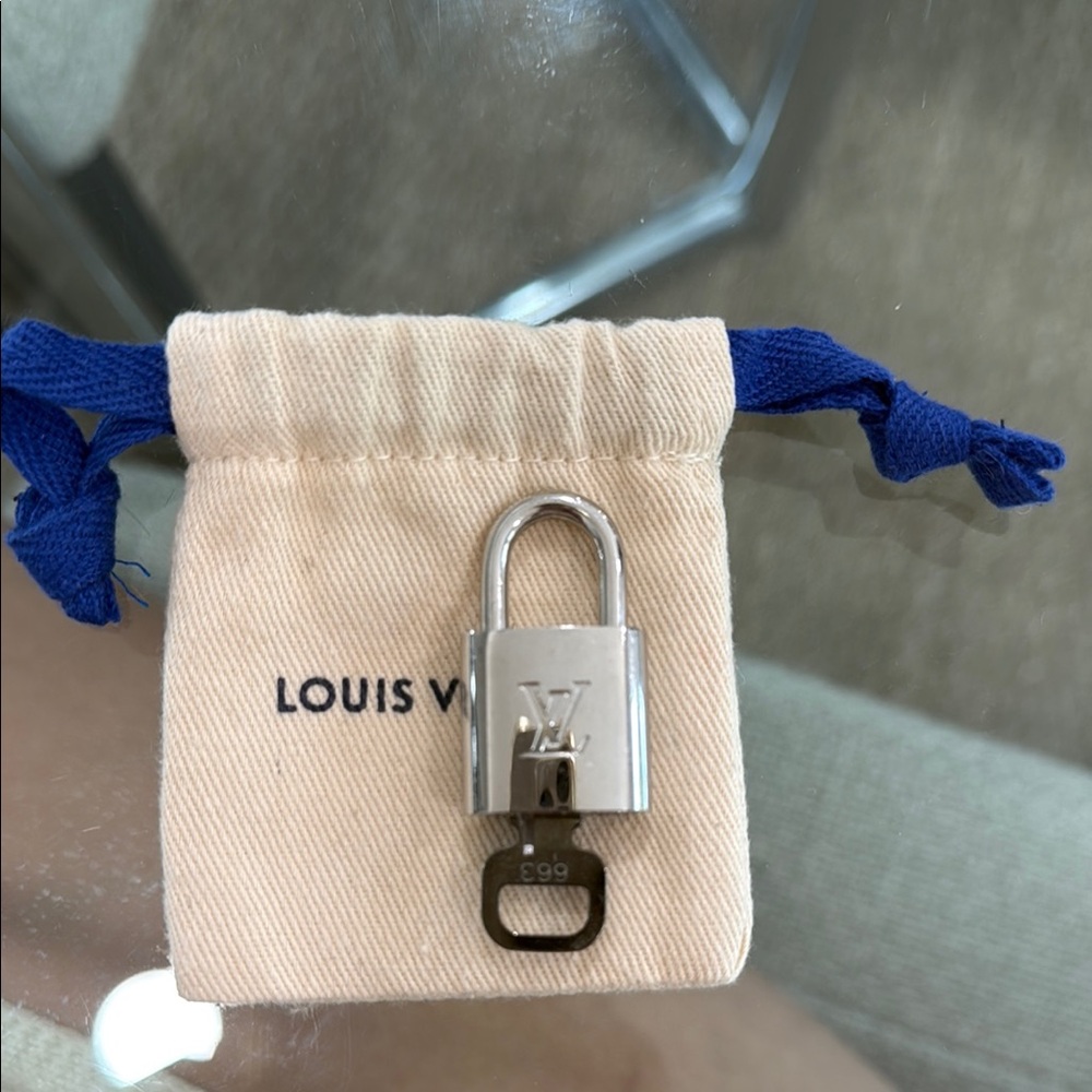 Louis Vuitton Authentic Silver Padlock with Cream Pouch